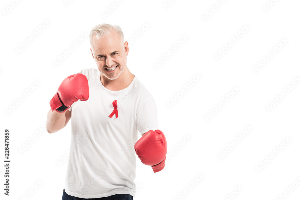 angry mature man in blank white t-shirt with aids awareness red ribbon and boxing gloves isolated on white, fighting aids concept angry mature man in blank white t-shirt with aids awareness red ribbon and boxing gloves isolated on white, fighting aids concept
