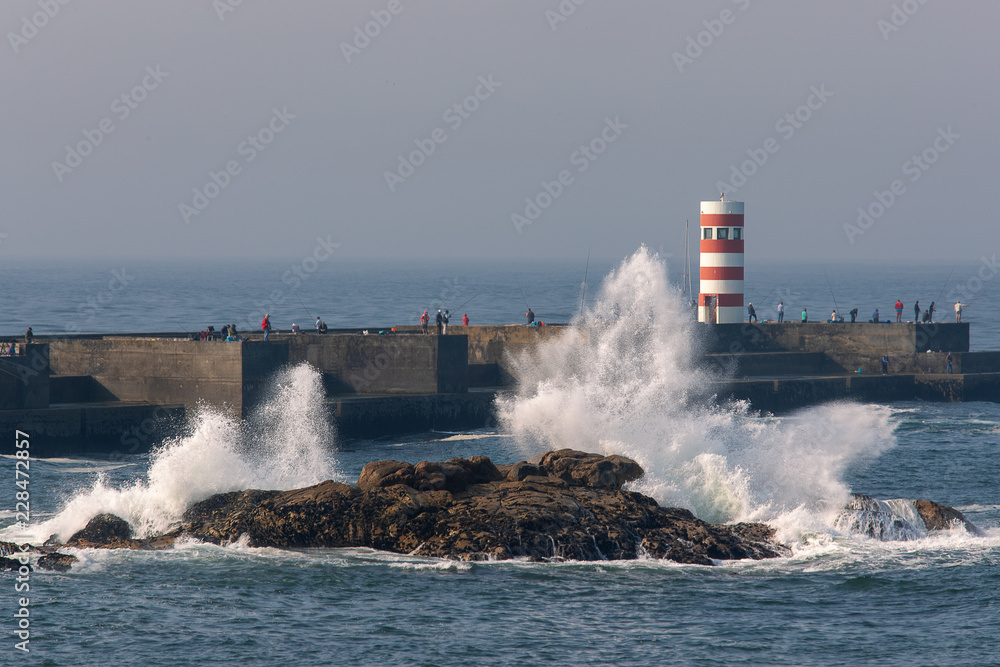 Waves crash the rocks near Felgueiras lighthouse in Porto city, Portugal