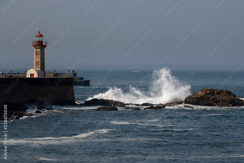 Waves crash the rocks near Felgueiras lighthouse in Porto city, Portugal