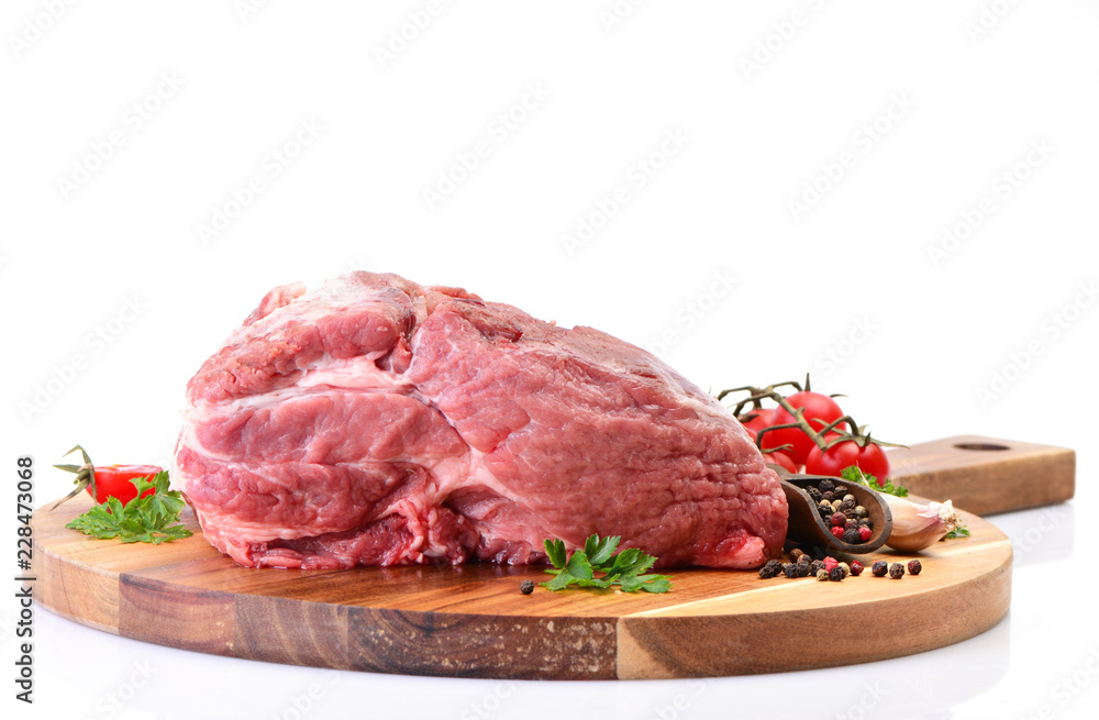 Pork meat with spices and vegetables on white background
