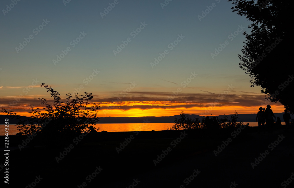 Lake. Sunset. Silhouette. People. Sky. Evening Lake. Sunset. Silhouette. People. Sky. Evening