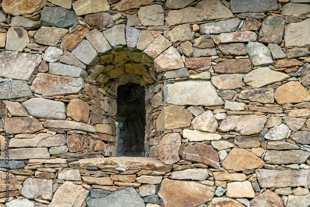 Arched window in stone wall