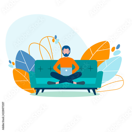 Young modern student freelancer, studying, working at home on the couch.