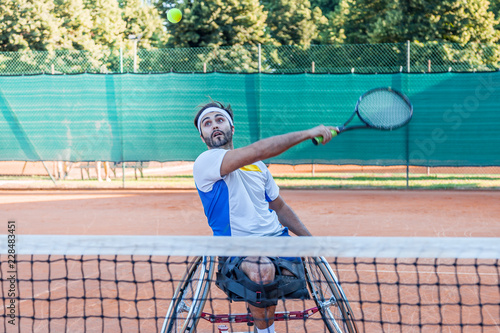disabled tennis player hits the ball backhand © Marino Bocelli