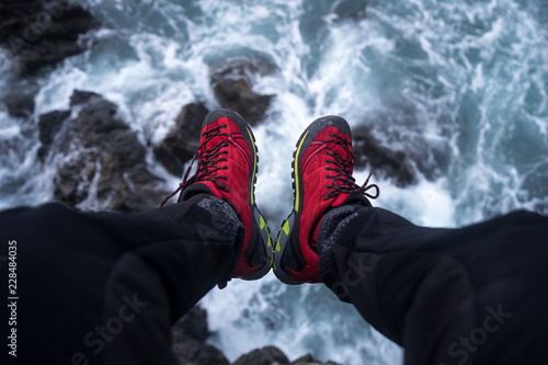 SITTING ON A CLIFF ABOVE THE SEA WAVES photo