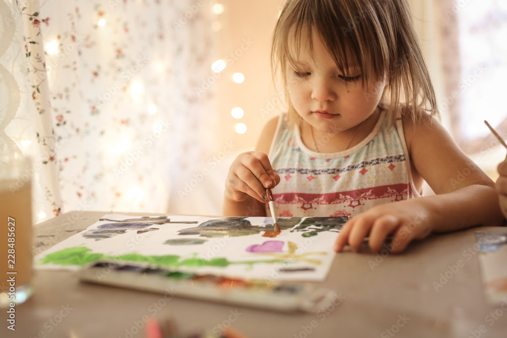 European child paints with watercolors, lifestyle European child paints with watercolors, lifestyle