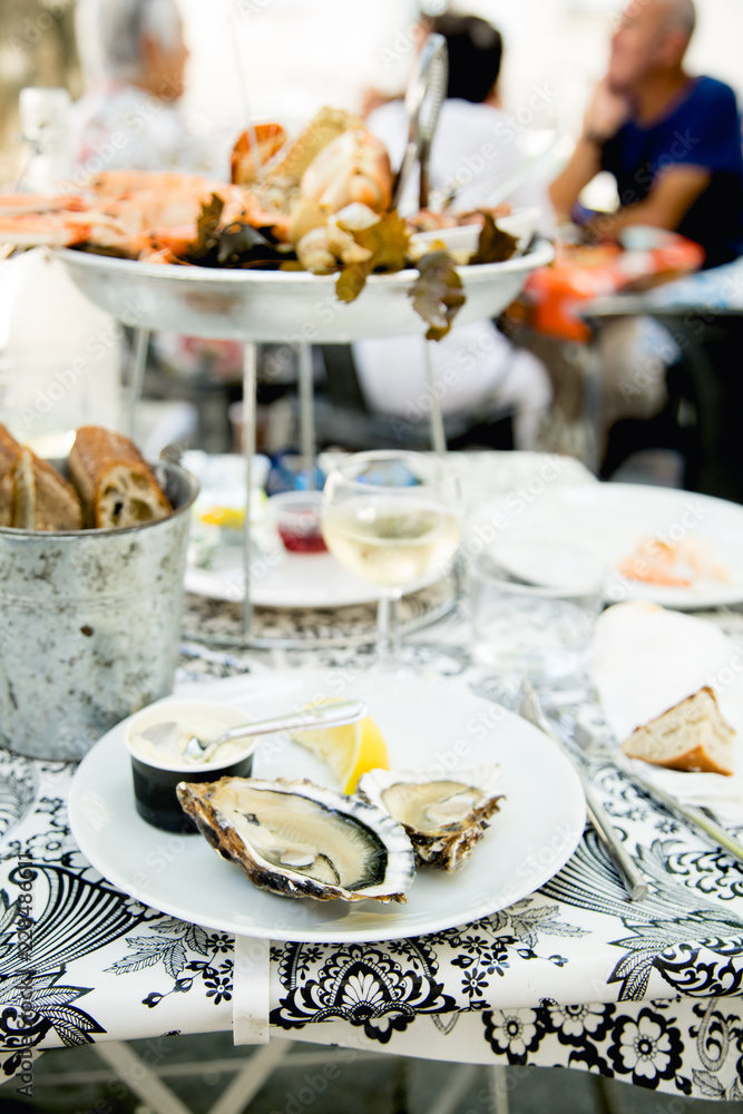 Plate with fresh assorted seafood in french summer restaurant Plate with fresh assorted seafood in french summer restaurant