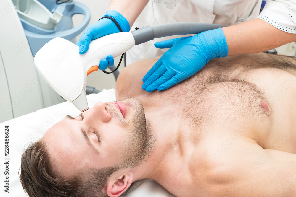Fototapeta premium Man on the procedure of laser hair removal in the beauty salon