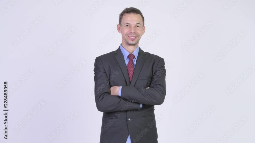 Studio shot of happy businessman with arms crossed Studio shot of happy businessman with arms crossed