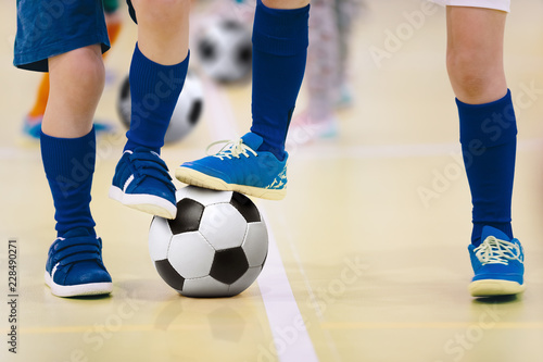 Indoor futsal soccer players playing futsal match. Indoor soccer sports hall. Futsal players kicking match. Futsal training dribbling drill. Sports background. Futsal league.