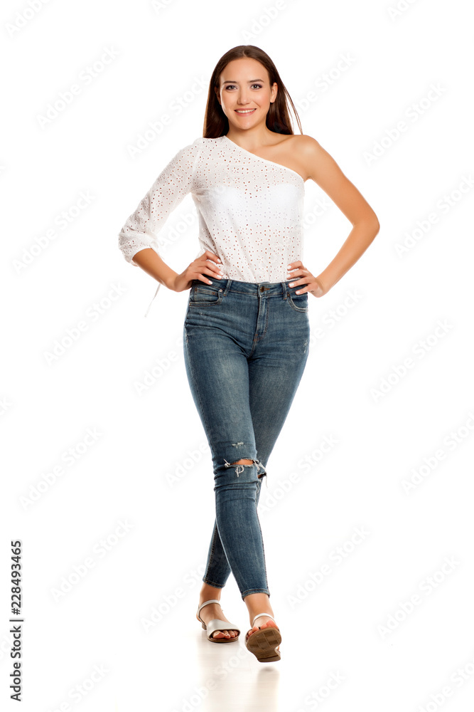 young beautiful girl in jeans walking on white backgeound young beautiful girl in jeans walking on white backgeound