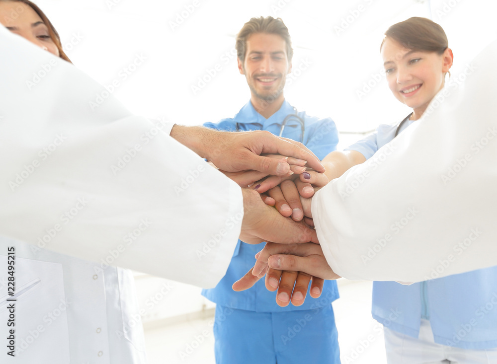Doctors and nurses in a medical team stacking hands Doctors and nurses in a medical team stacking hands