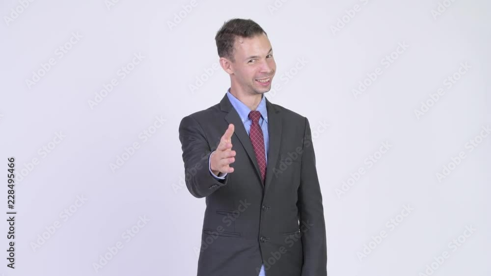 Studio shot of happy businessman giving handshake Studio shot of happy businessman giving handshake