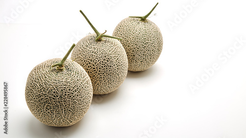 Three cantaloupe melon on white