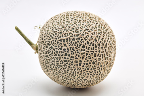 Single cantaloupe melon on white