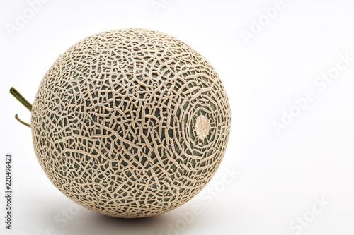 Single cantaloupe melon on white