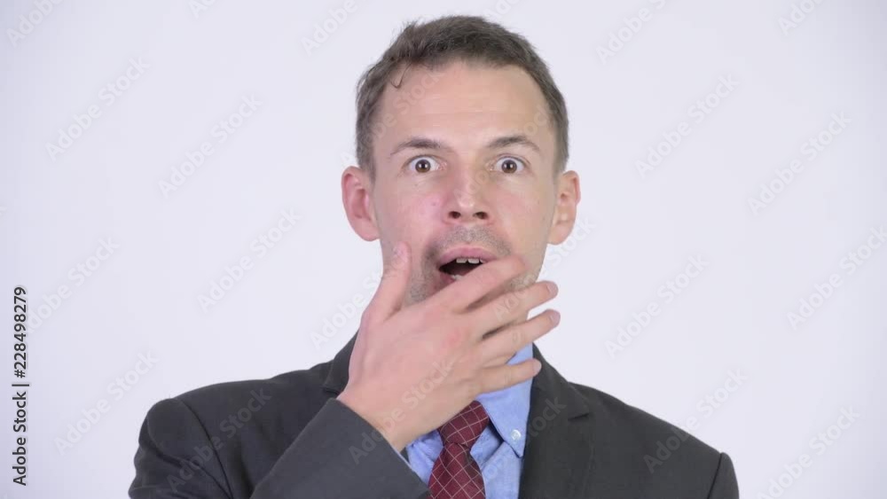 Studio shot of businessman looking shocked Studio shot of businessman looking shocked