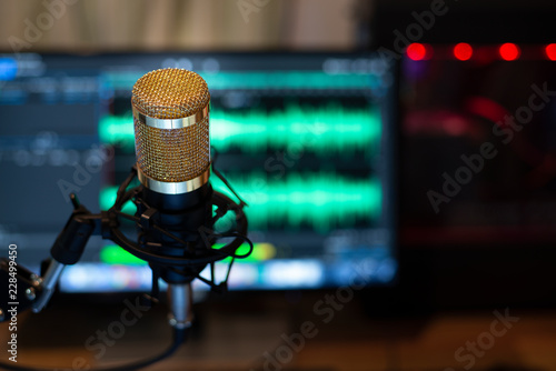 Gold condenser microphone and the computer is recording, Crose up.