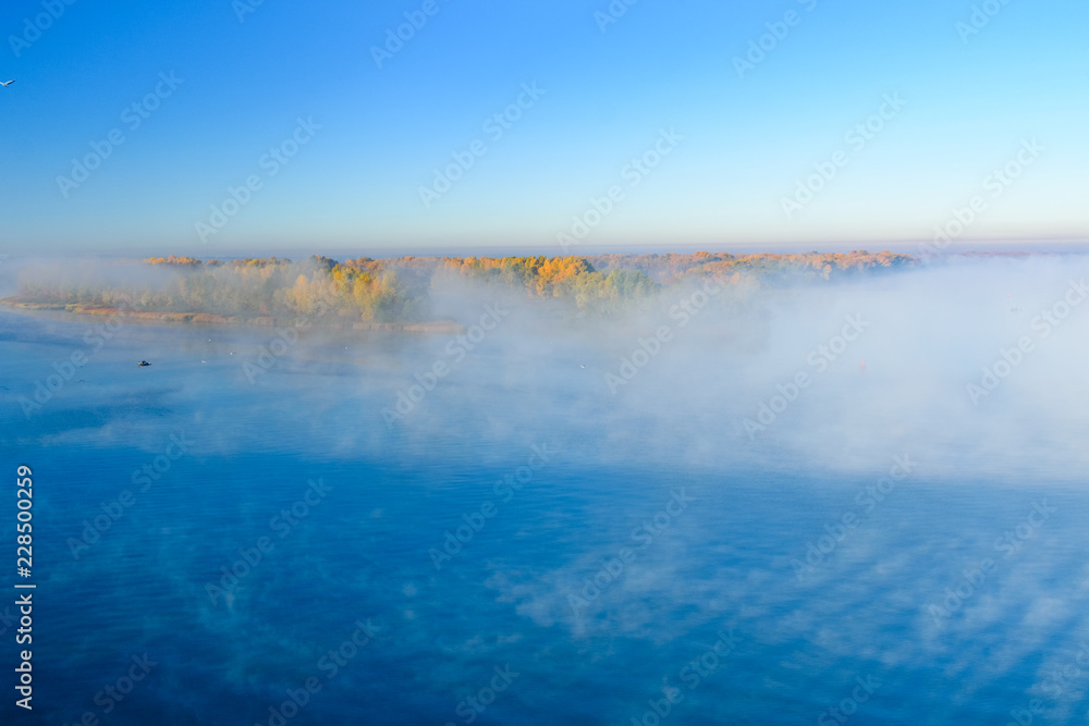 Obraz premium Fog over the water on a river Dnieper on autumn