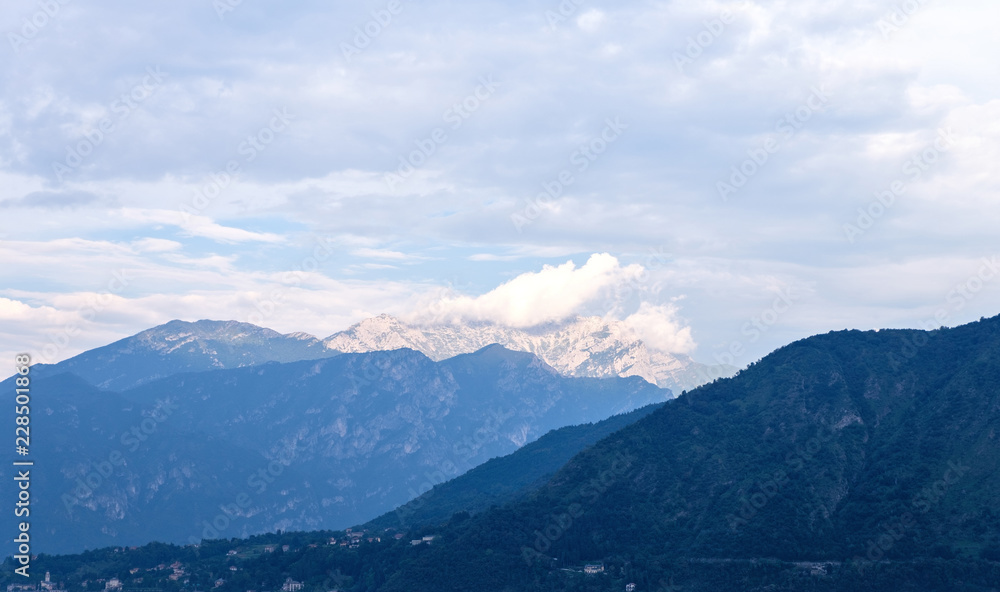 White mountains far away from Lake Como