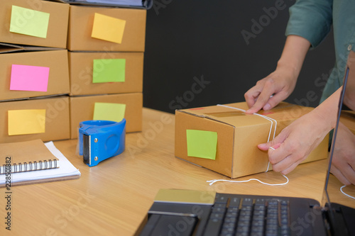 startup business owner packing cardboard box. woman seller prepare product parcel box for delivery. Online selling, e-commerce concept