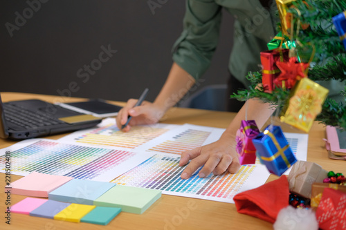 graphic interior designer choosing color from swatch sample catalogue palette guide