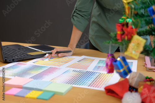 graphic interior designer choosing color from swatch sample catalogue palette guide