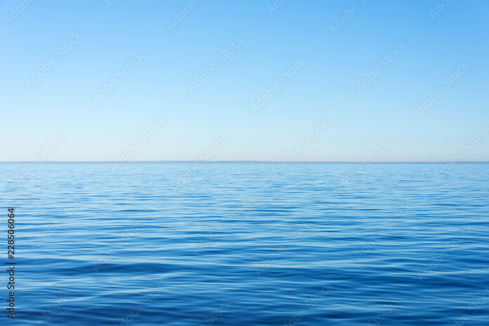 Quiet calm surface of water, sea and horizon and clear sky.