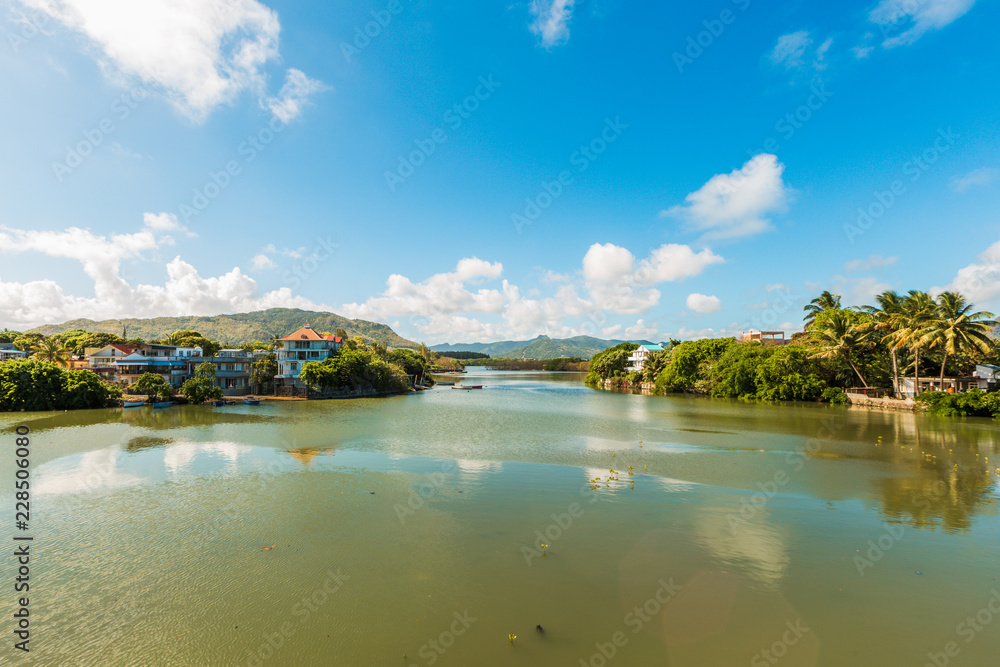 River scene with mountains in Mahebourg, Mauritius. Mauritius, an Indian Ocean island nation, is known for its beaches, lagoons and reefs.
