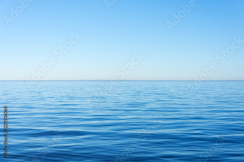 Quiet calm surface of water, sea and horizon and clear sky.