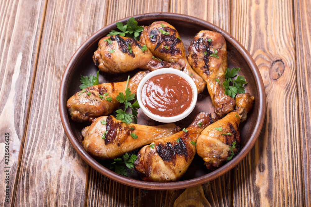 Fototapeta premium Grilled chicken legs with tomato sauce