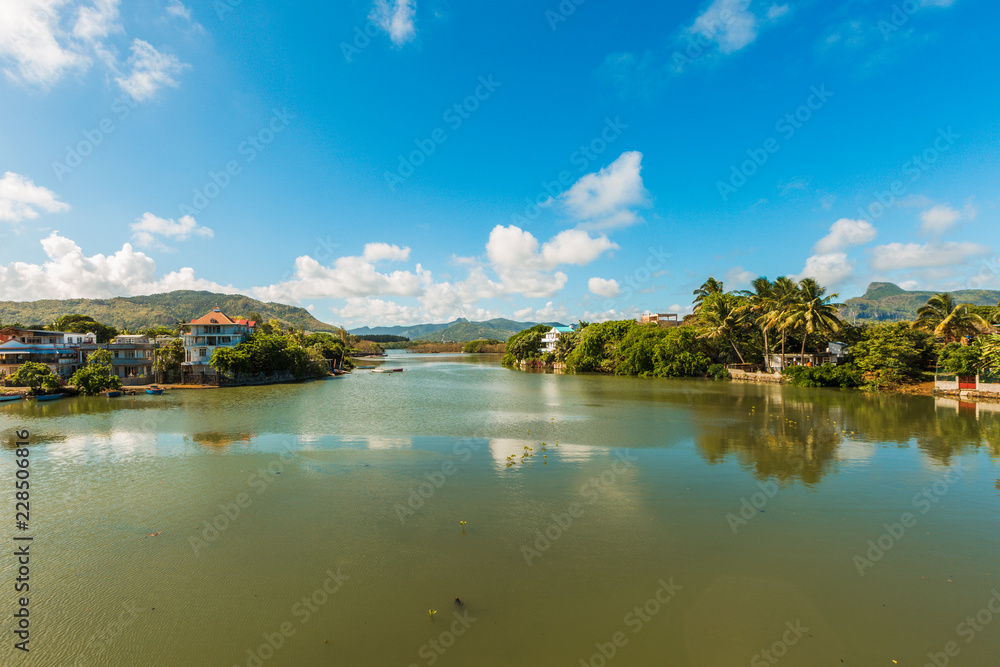 River scene with mountains in Mahebourg, Mauritius. Mauritius, an Indian Ocean island nation, is known for its beaches, lagoons and reefs.