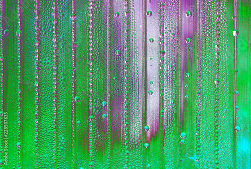 abstract background with big and small water drops in different colors - acid green with violet © a_darya