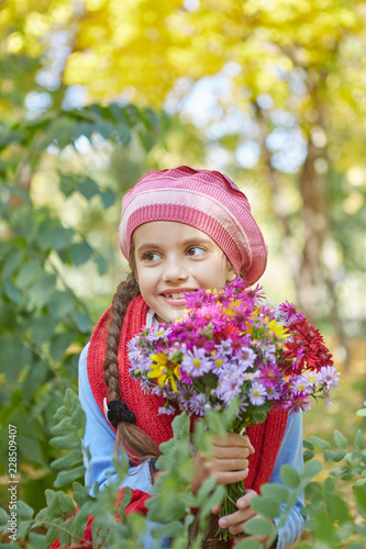 Beautiful happy girl in autumn park.