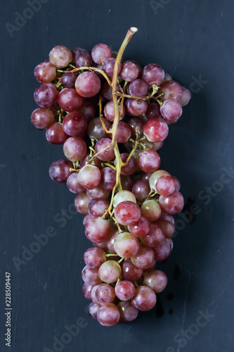 Red grapes on a black background