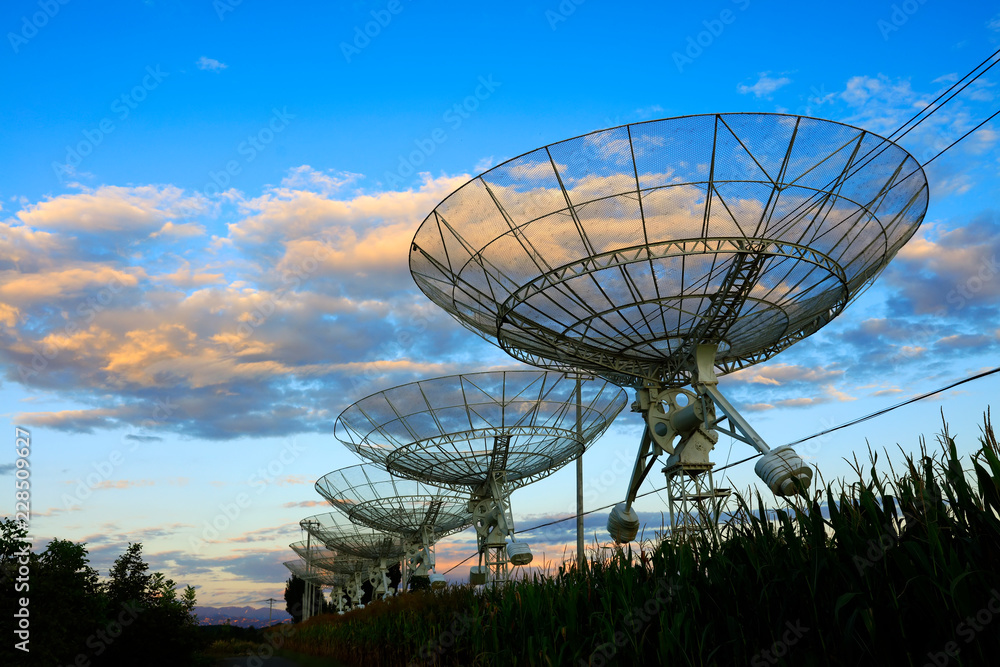 The silhouette of a radio telescope