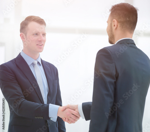 handshake financial partners in the corridor of the office