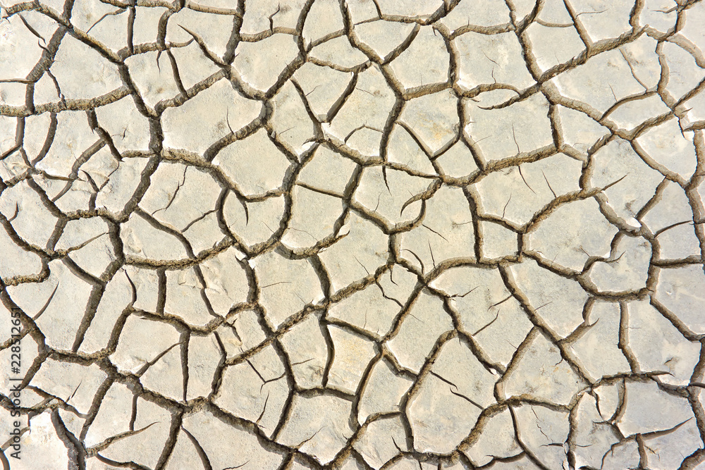Pattern of cracked ground at the seashore. Brown, beige, light tan and grey colored background. Pattern of cracked ground at the seashore. Brown, beige, light tan and grey colored background.
