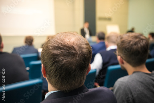 People sitting rear at the business conference. Back view