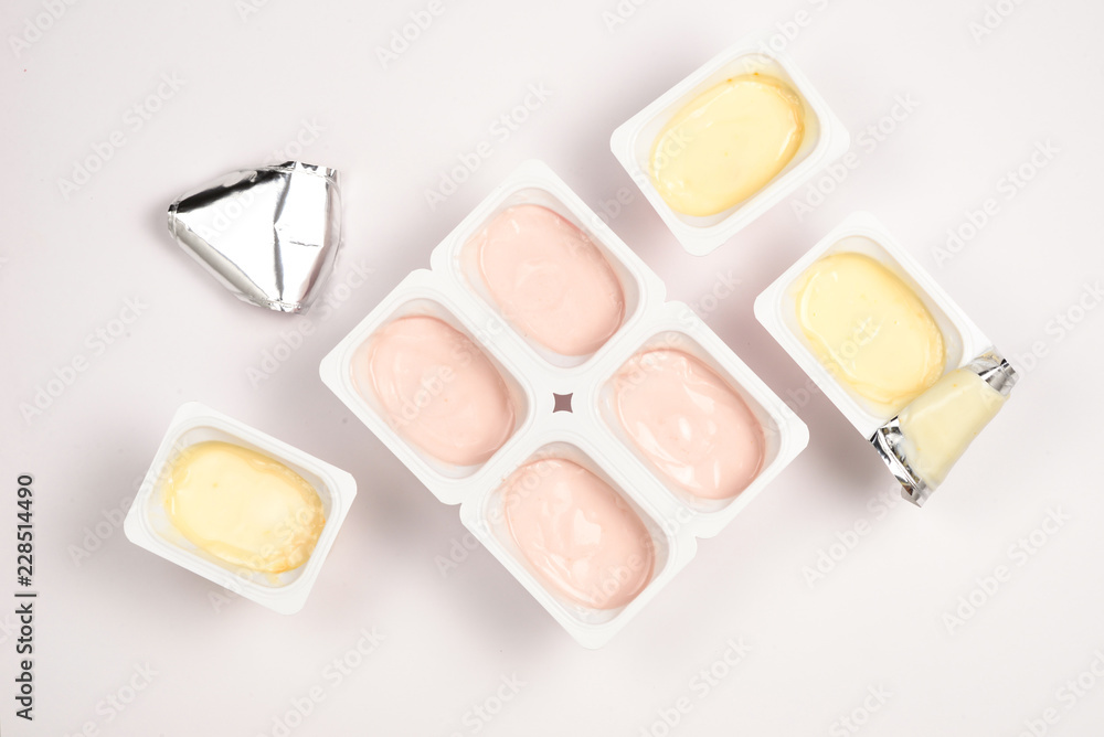 Plastic cup with tasty yogurt isolated on white. Top view. Space for text or design. Plastic cup with tasty yogurt isolated on white. Top view. Space for text or design.
