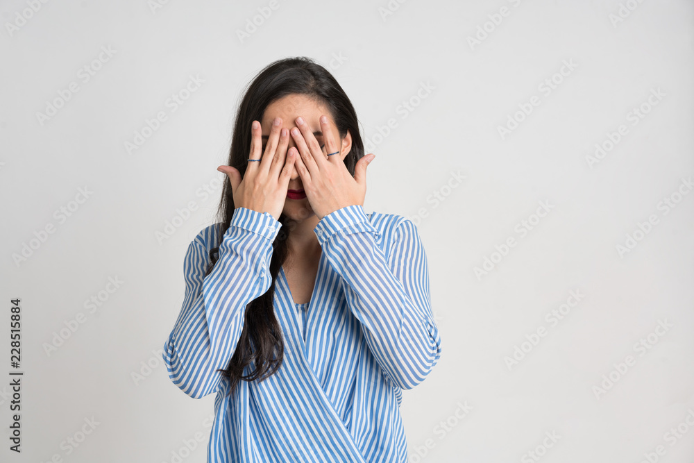 Woman with her hands covering her eyes Woman with her hands covering her eyes