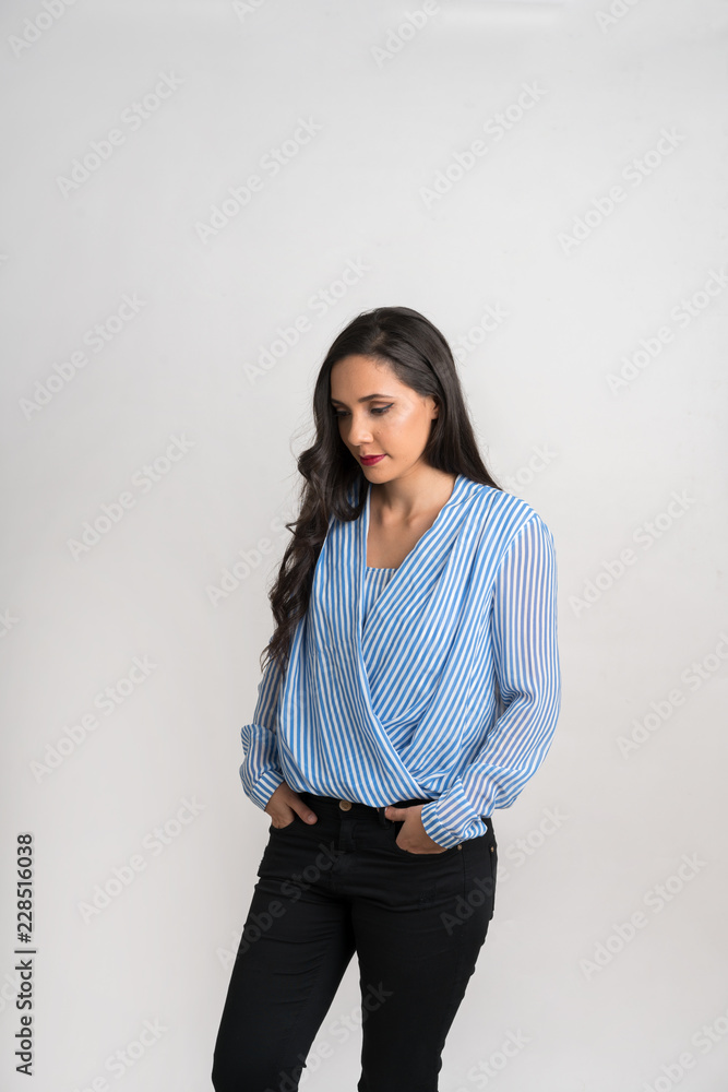 Woman posing with hands in pockest looking left Woman posing with hands in pockest looking left
