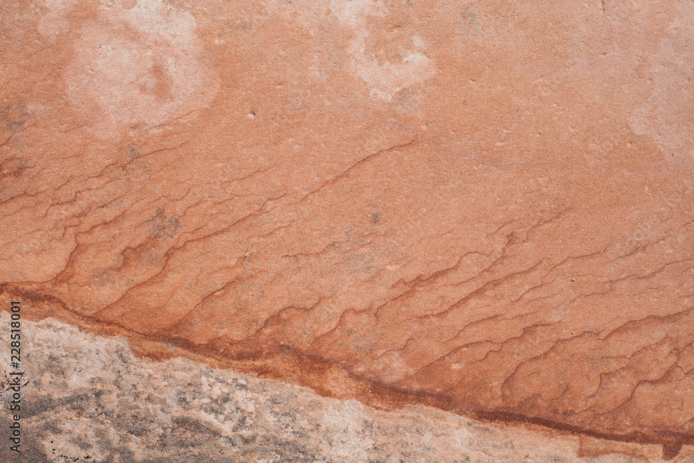 Iron in the sandstone marks the layers of stratification with different shades of red.