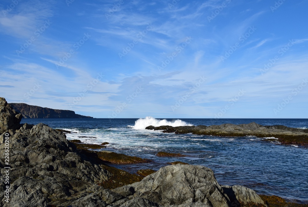 seascape with a wave hitting a rock in the ocean making a big splash seascape with a wave hitting a rock in the ocean making a big splash