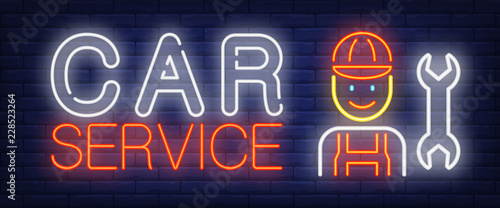 Car service neon text with mechanic and wrench. Car service and repair advertisement design. Night bright neon sign, colorful billboard, light banner. Vector illustration in neon style.