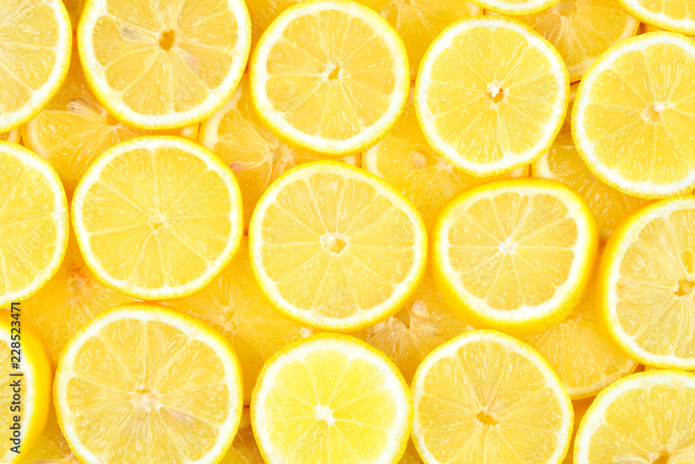 A slices of fresh juicy yellow lemons. Texture background, pattern. A slices of fresh juicy yellow lemons. Texture background, pattern.