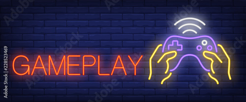 Gameplay neon text with hands holding joystick. Video games and entertainment advertisement design. Night bright neon sign, colorful billboard, light banner. Vector illustration in neon style.