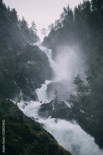 Rapid and powerful mountain waterfall in Norway 