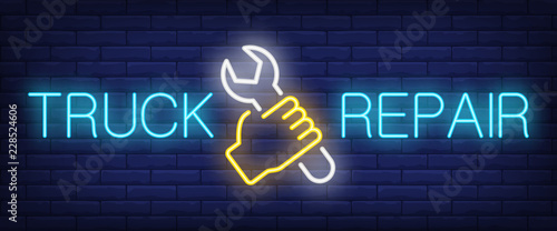 Truck repair neon text with hand holding wrench. Car service and repair advertisement design. Night bright neon sign, colorful billboard, light banner. Vector illustration in neon style.