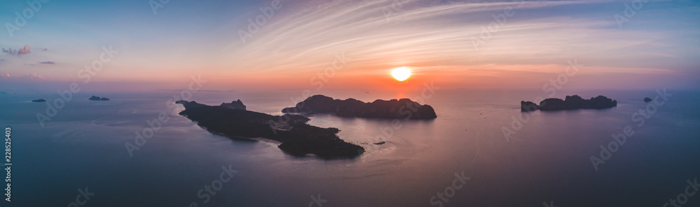 Aerial drone view of tropical silhouette islands in sunset time. Indian ocean. Travelling and holiday concept. Top view panorama. Travel Background. Nature landscape.